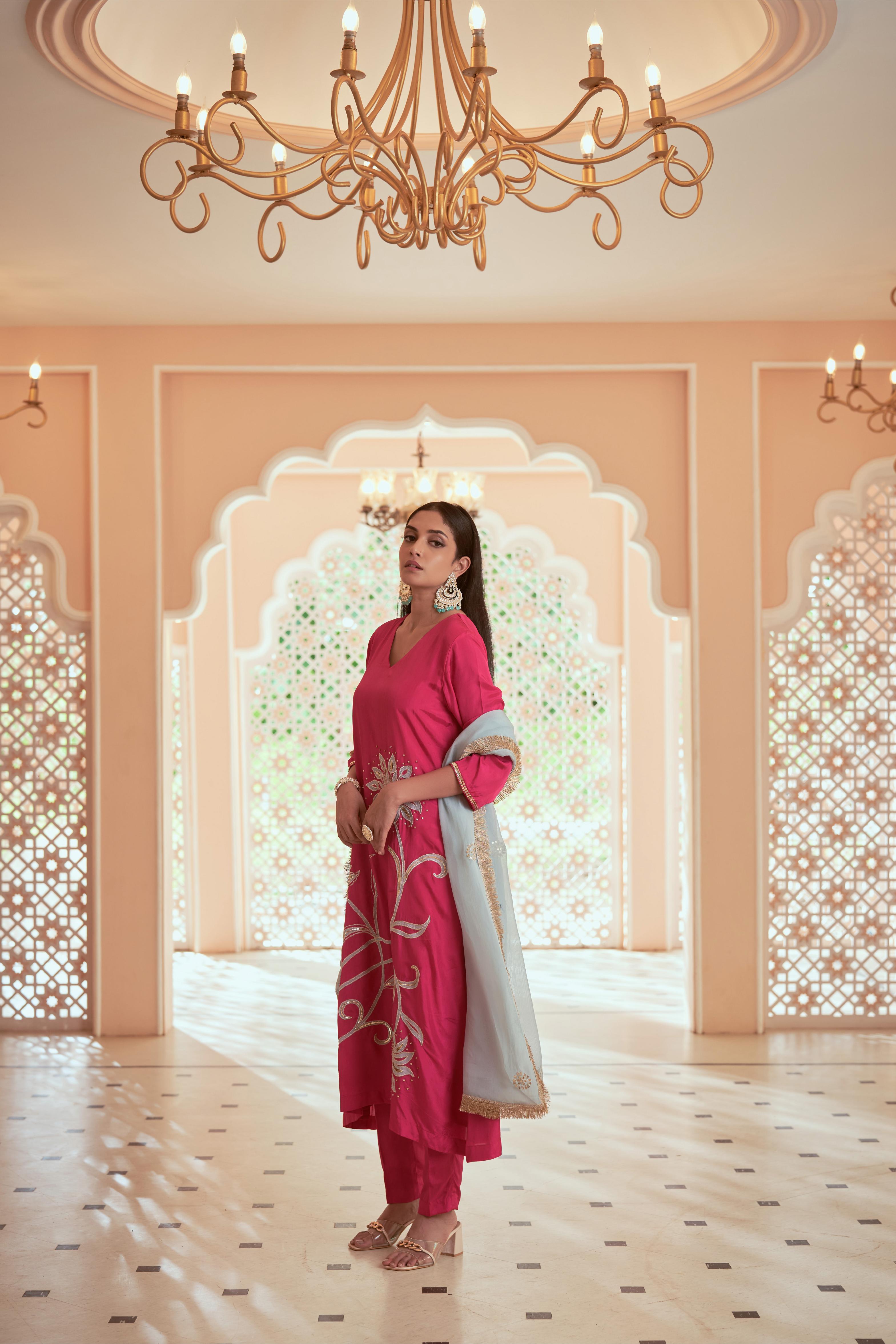 Featuring bright pink Silk embroidered Kurta set paired with embroidered organza dupatta adorned with fringe lace