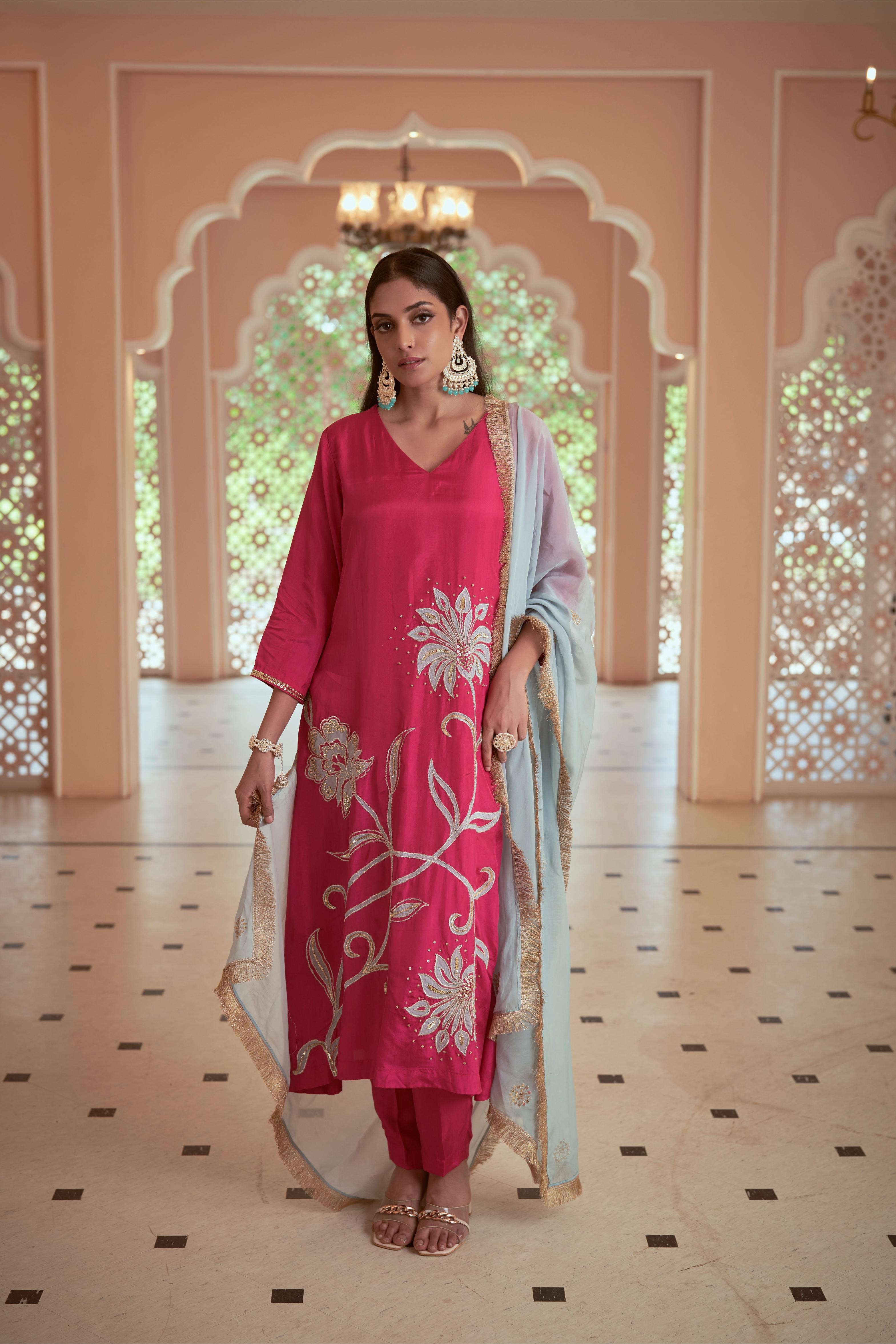 Featuring bright pink Silk embroidered Kurta set paired with embroidered organza dupatta adorned with fringe lace