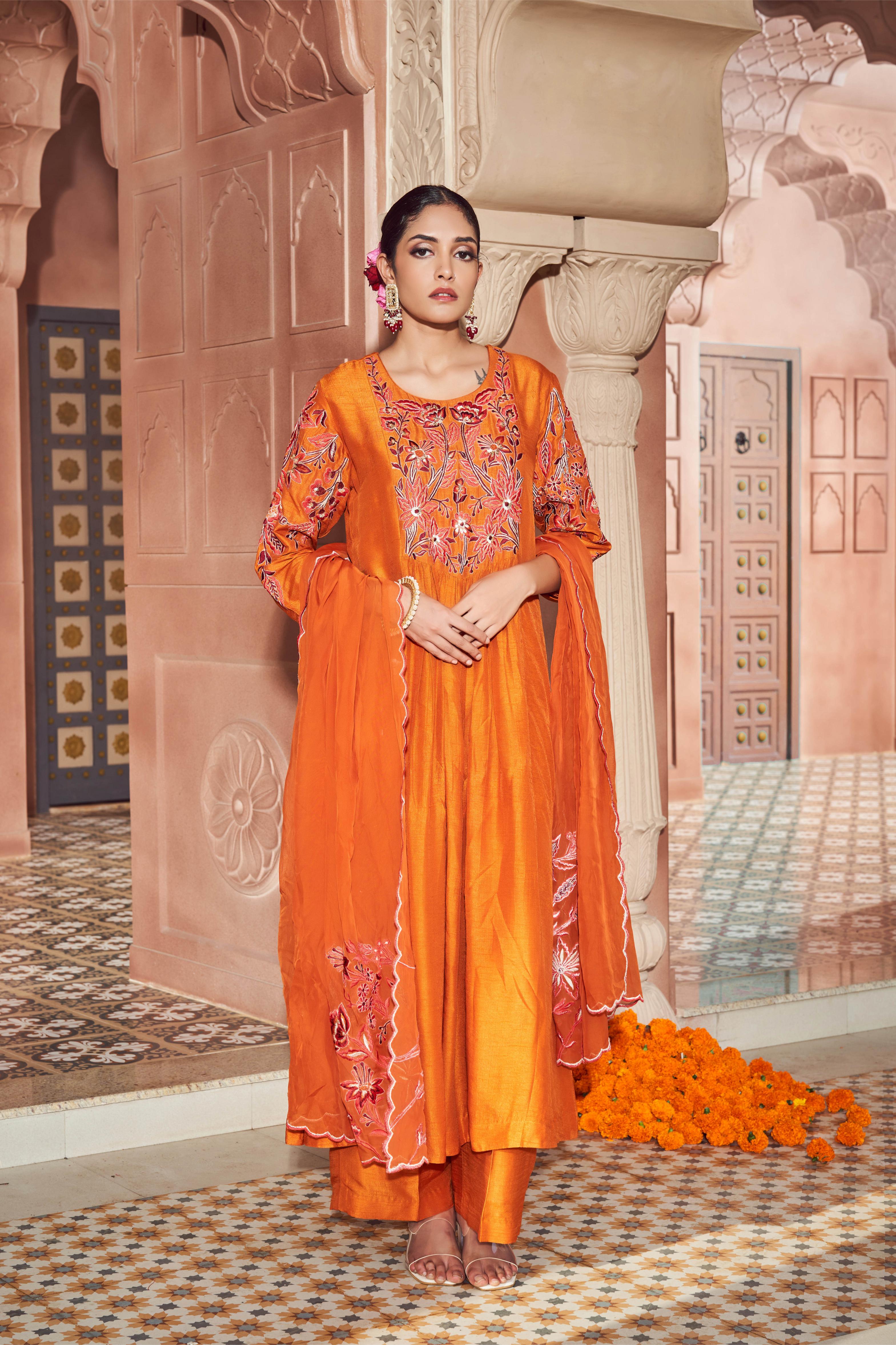 Featuring orange silk embroidered kurta paired with embroidered organza dupatta and plain silk pant