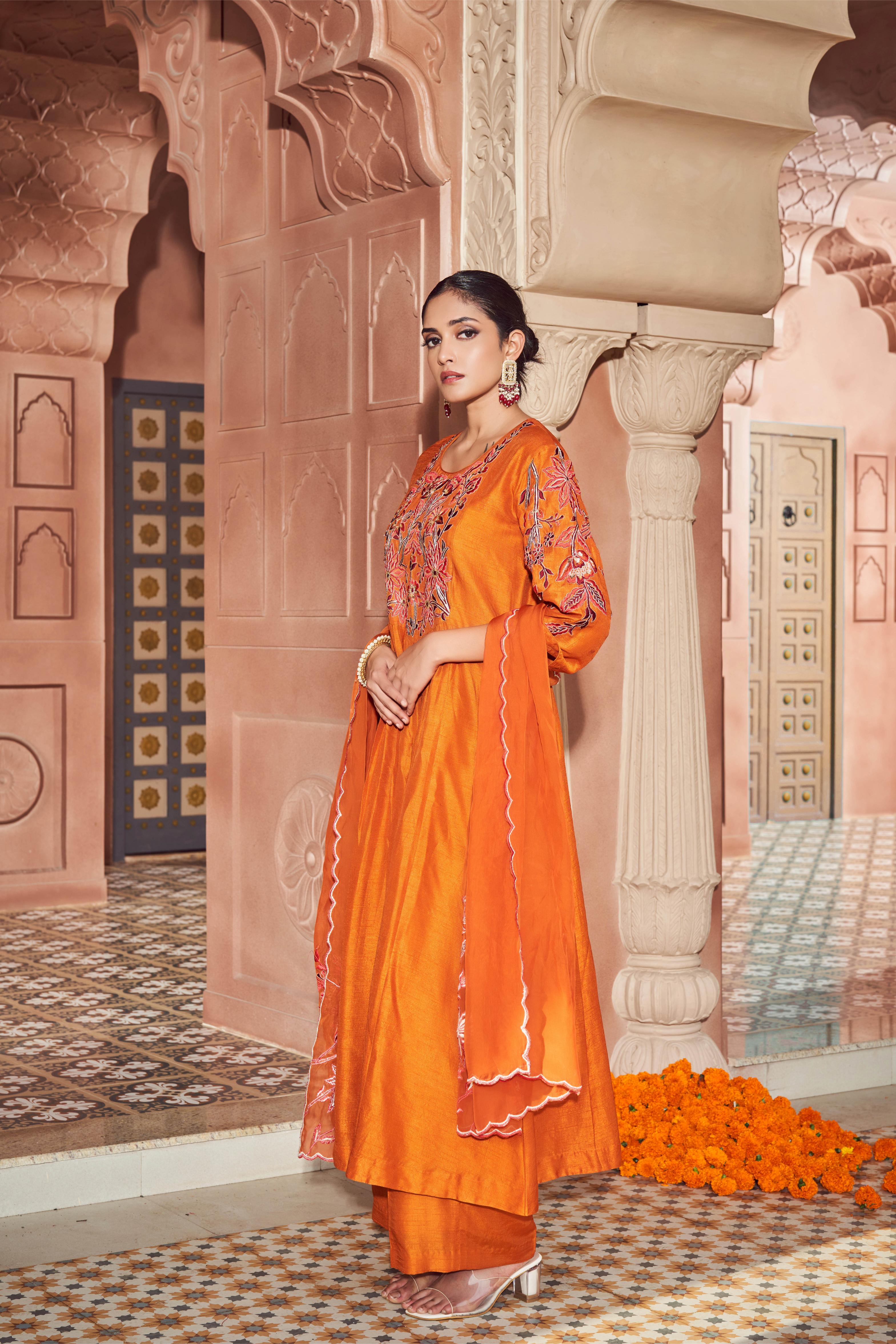 Featuring orange silk embroidered kurta paired with embroidered organza dupatta and plain silk pant