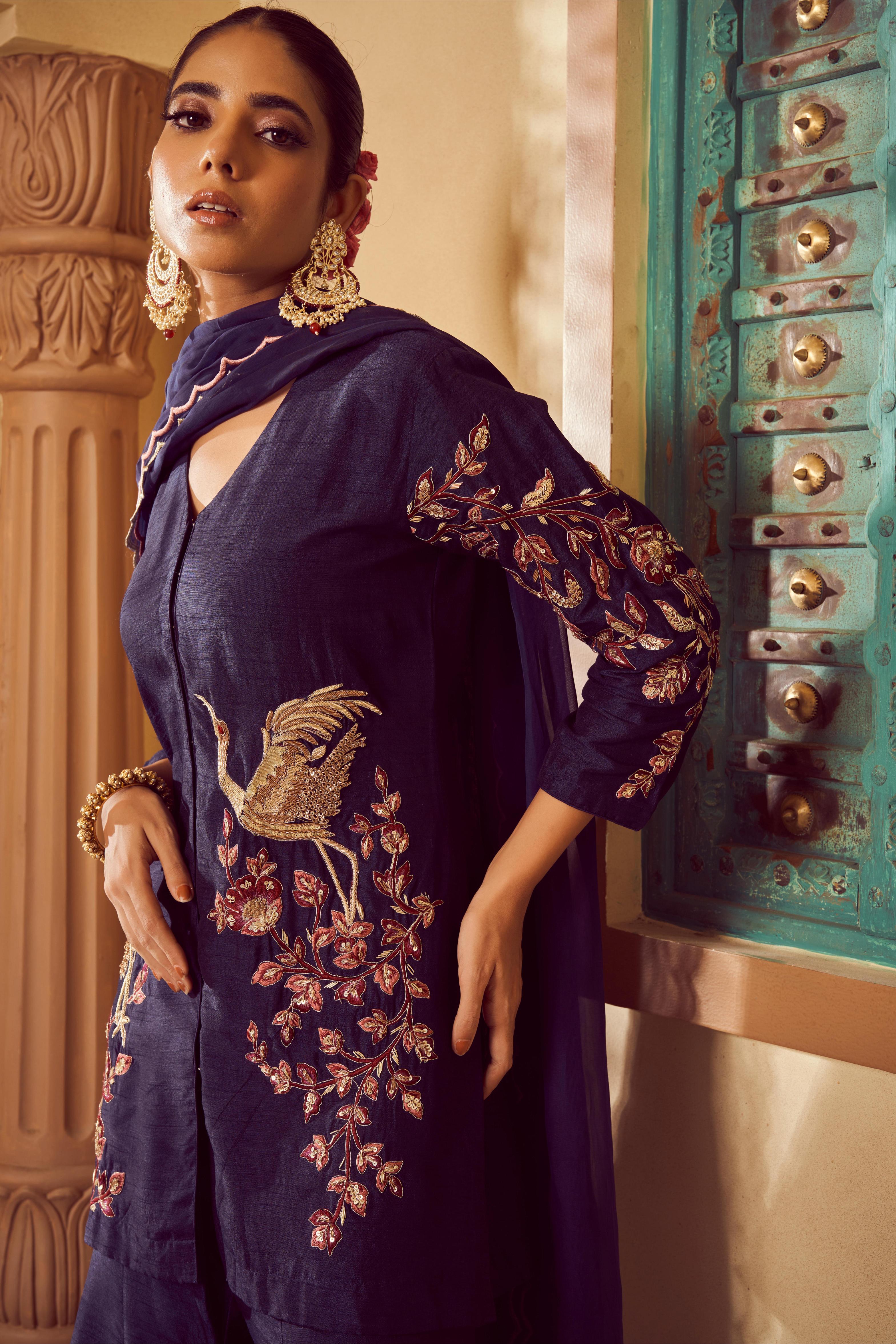 Featuring dark Blue silk embroidered short kurti paired with plain silk sharara and organza dupatta