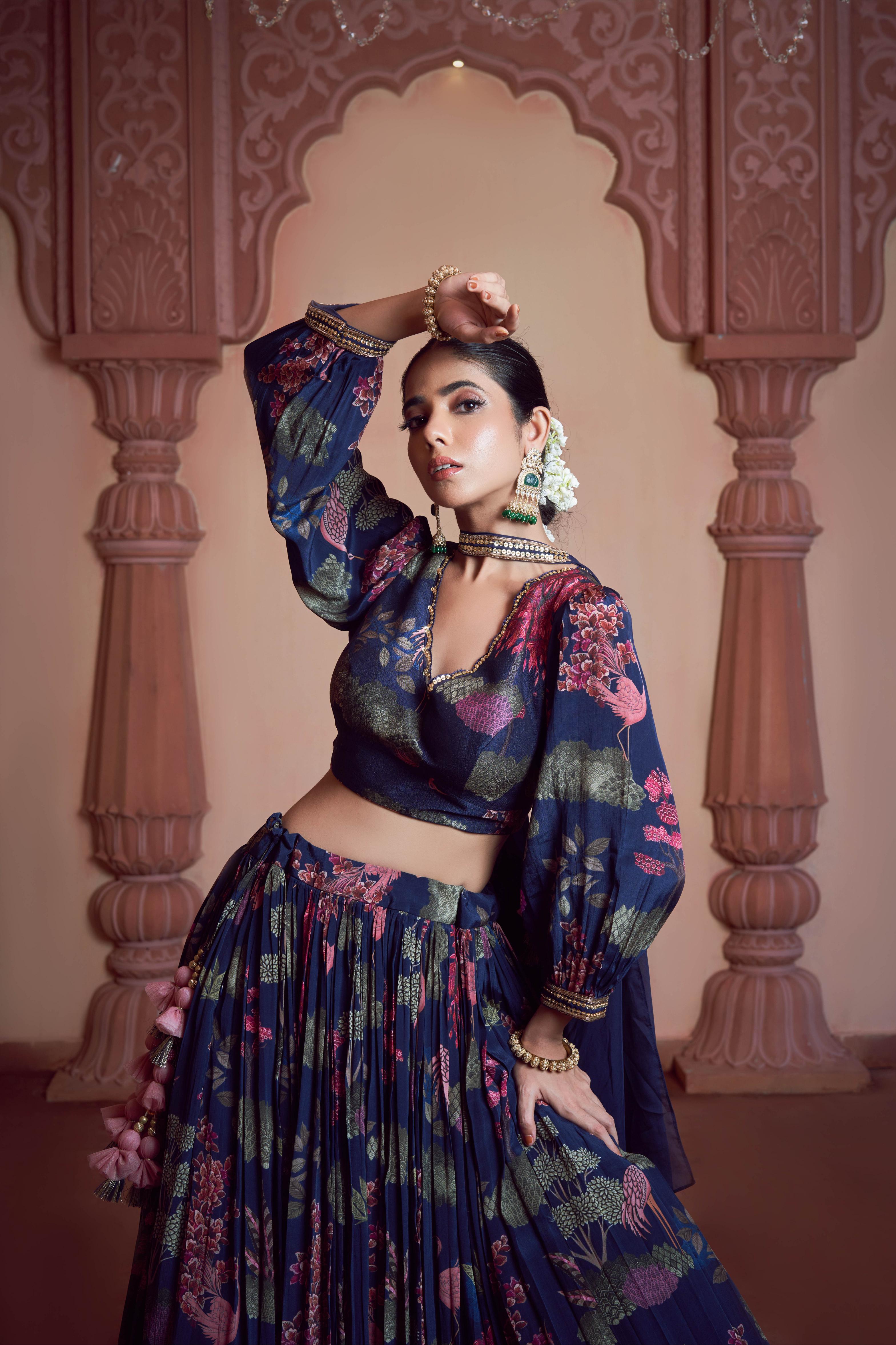 Featuring blue signature print crepe lehenga paired with printed silk blouse and organza dupatta embellished with hadn embroidery