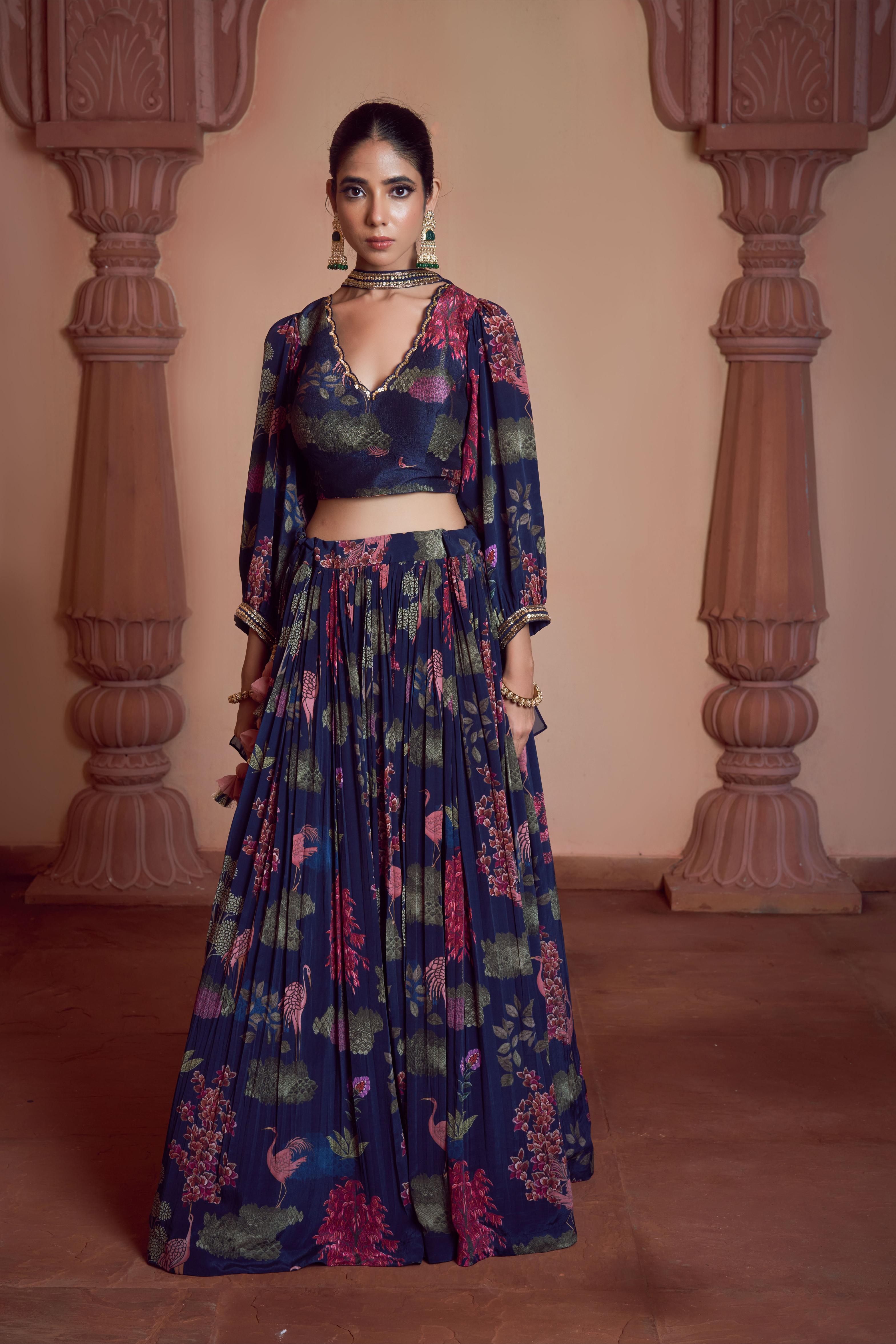 Featuring blue signature print crepe lehenga paired with printed silk blouse and organza dupatta embellished with hadn embroidery