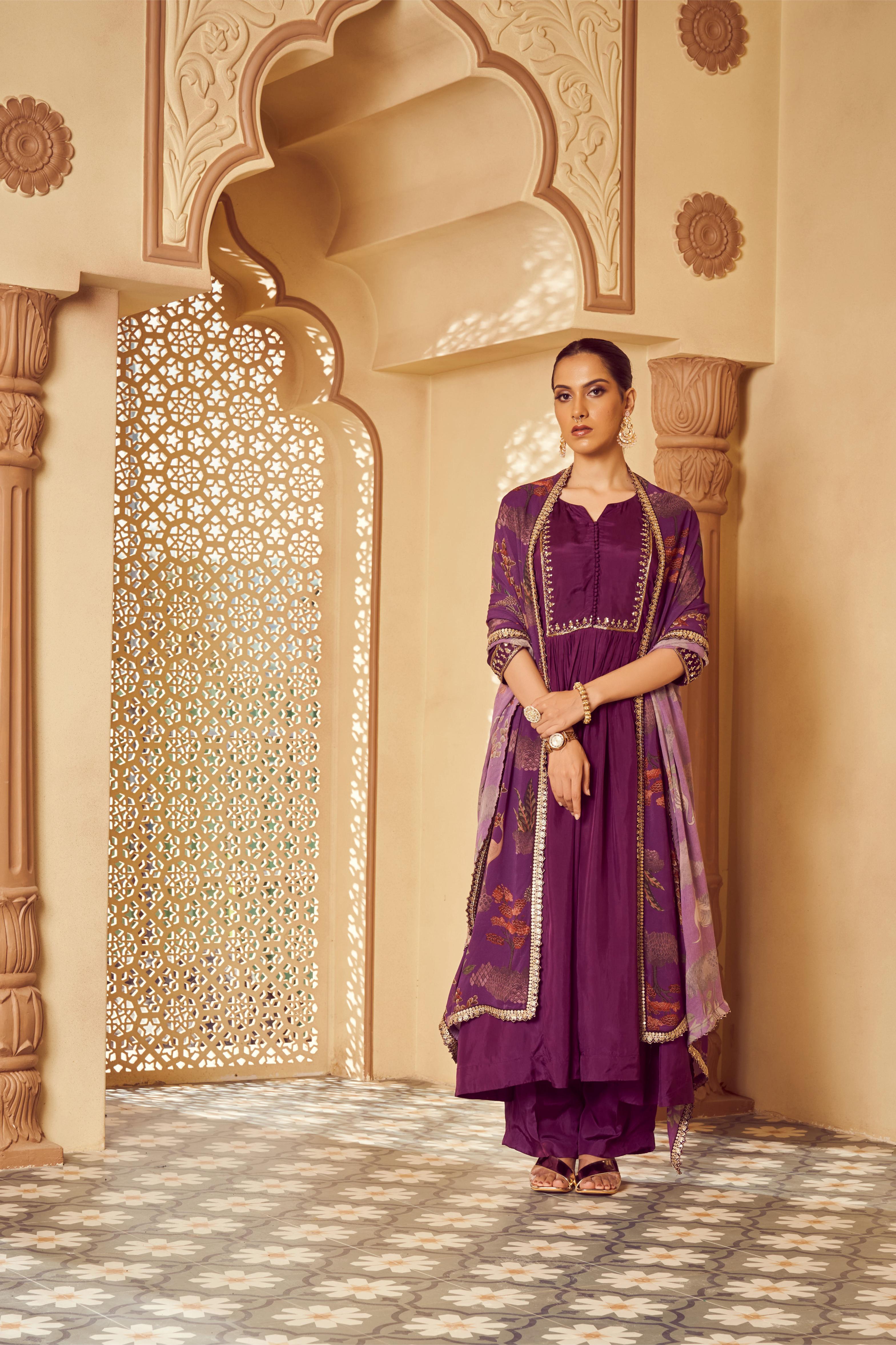 Featuring Purple silk embroidered kurti paired with silk pants and signature print georgette dupatta