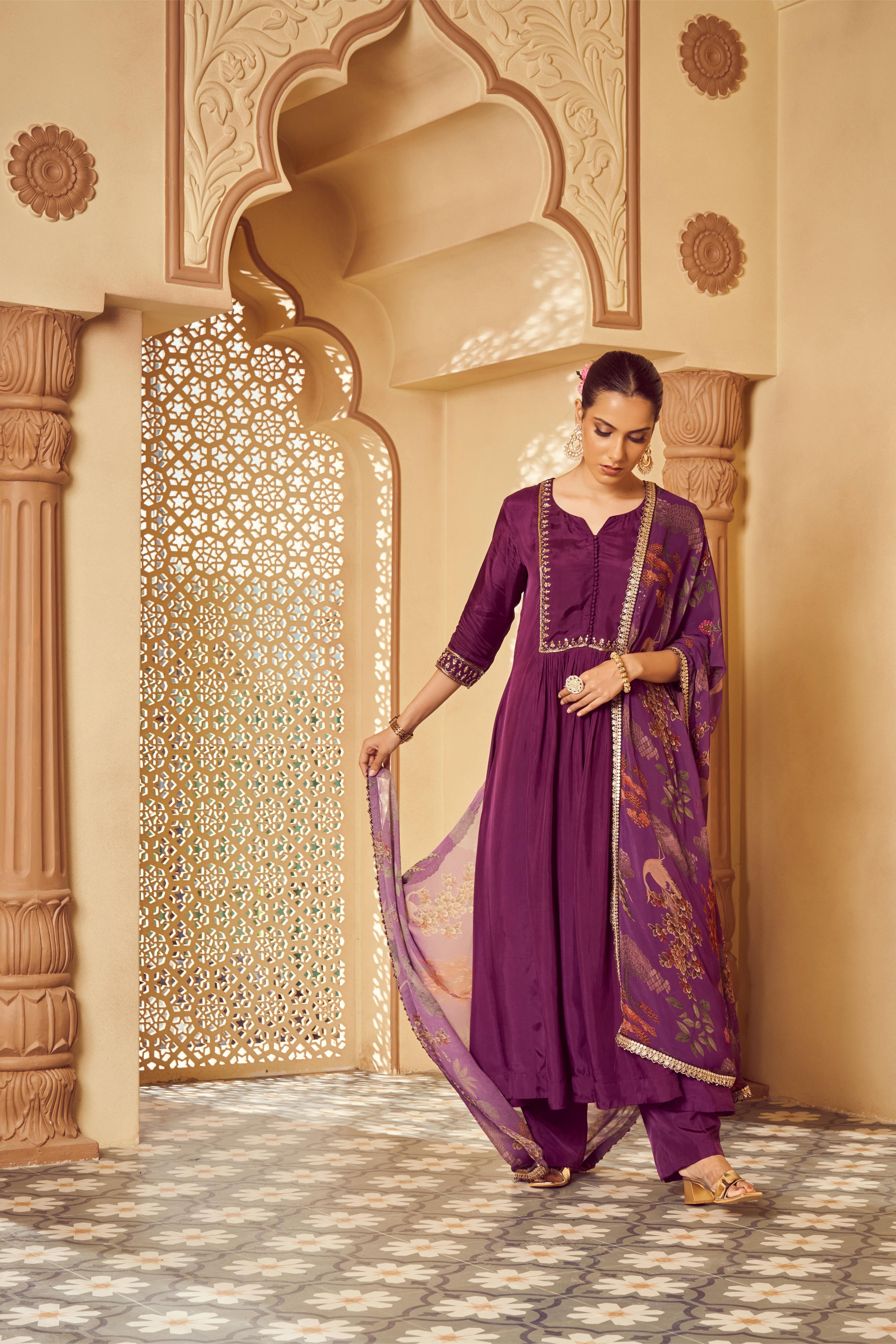 Featuring Purple silk embroidered kurti paired with silk pants and signature print georgette dupatta