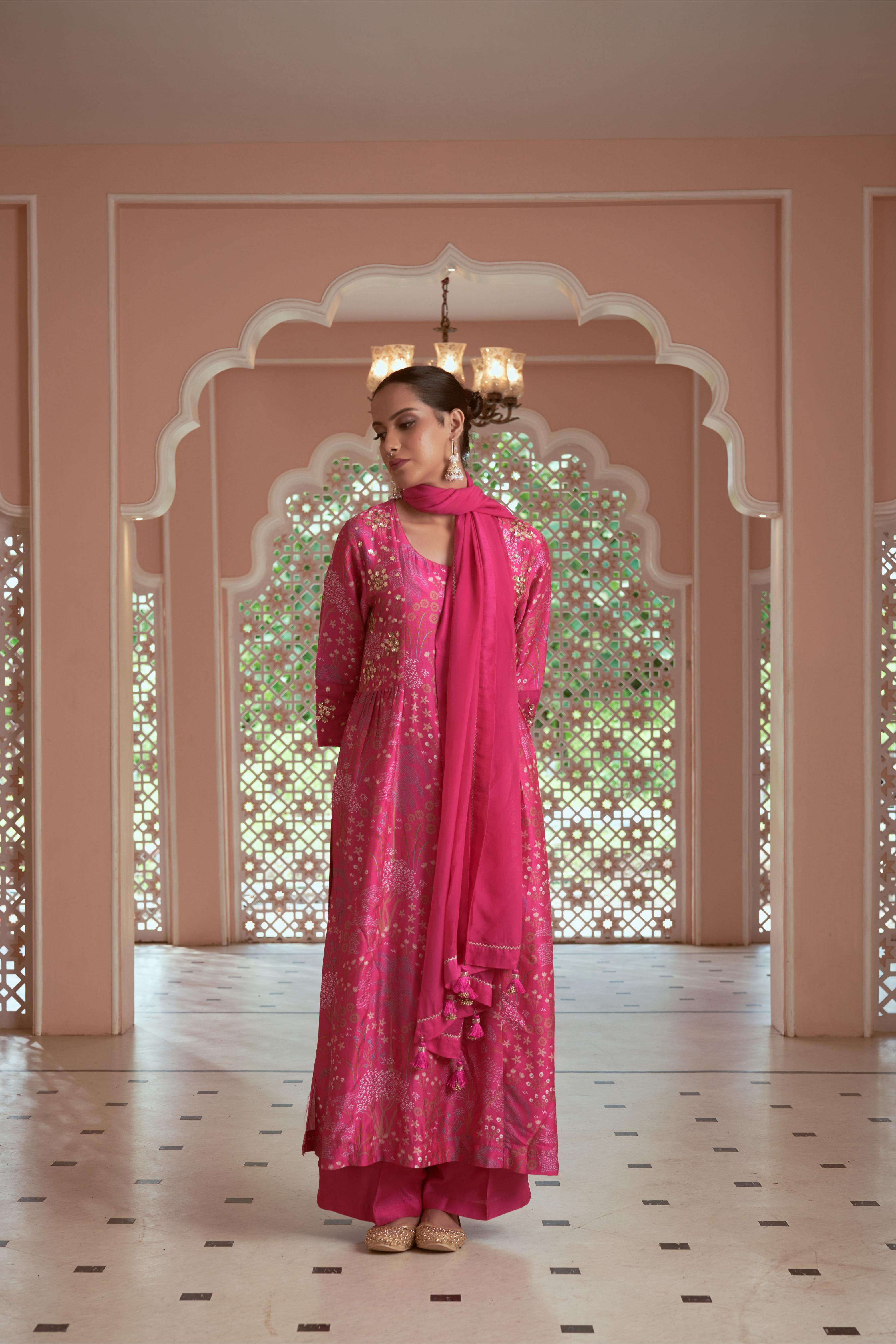 Featuring signature print pink kurti adorned with hand embroidery paired with silk pants and organza dupatta