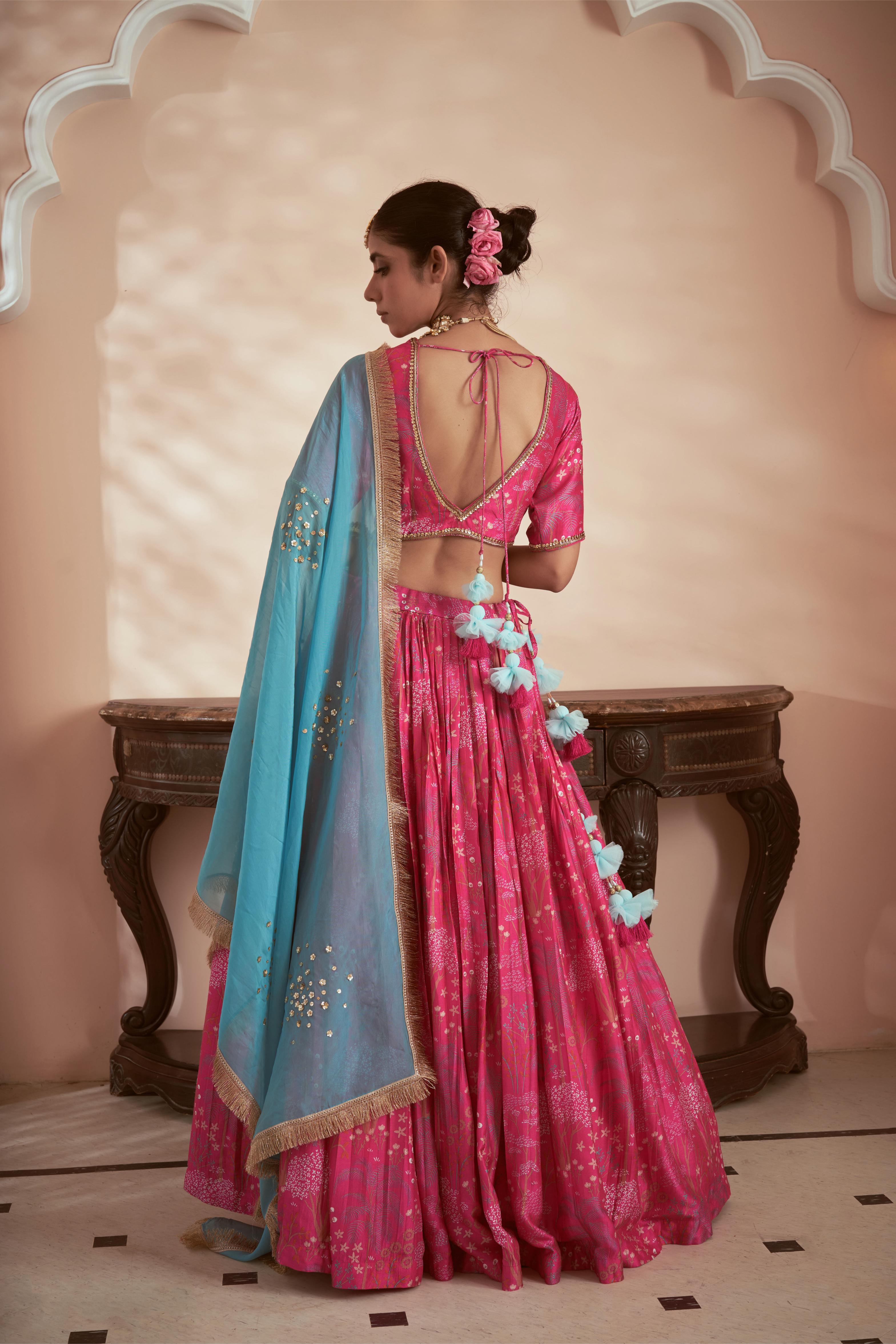 Featuring Pink signature print lehenga set paired with blue organza dupatta embellished with hand embroidery