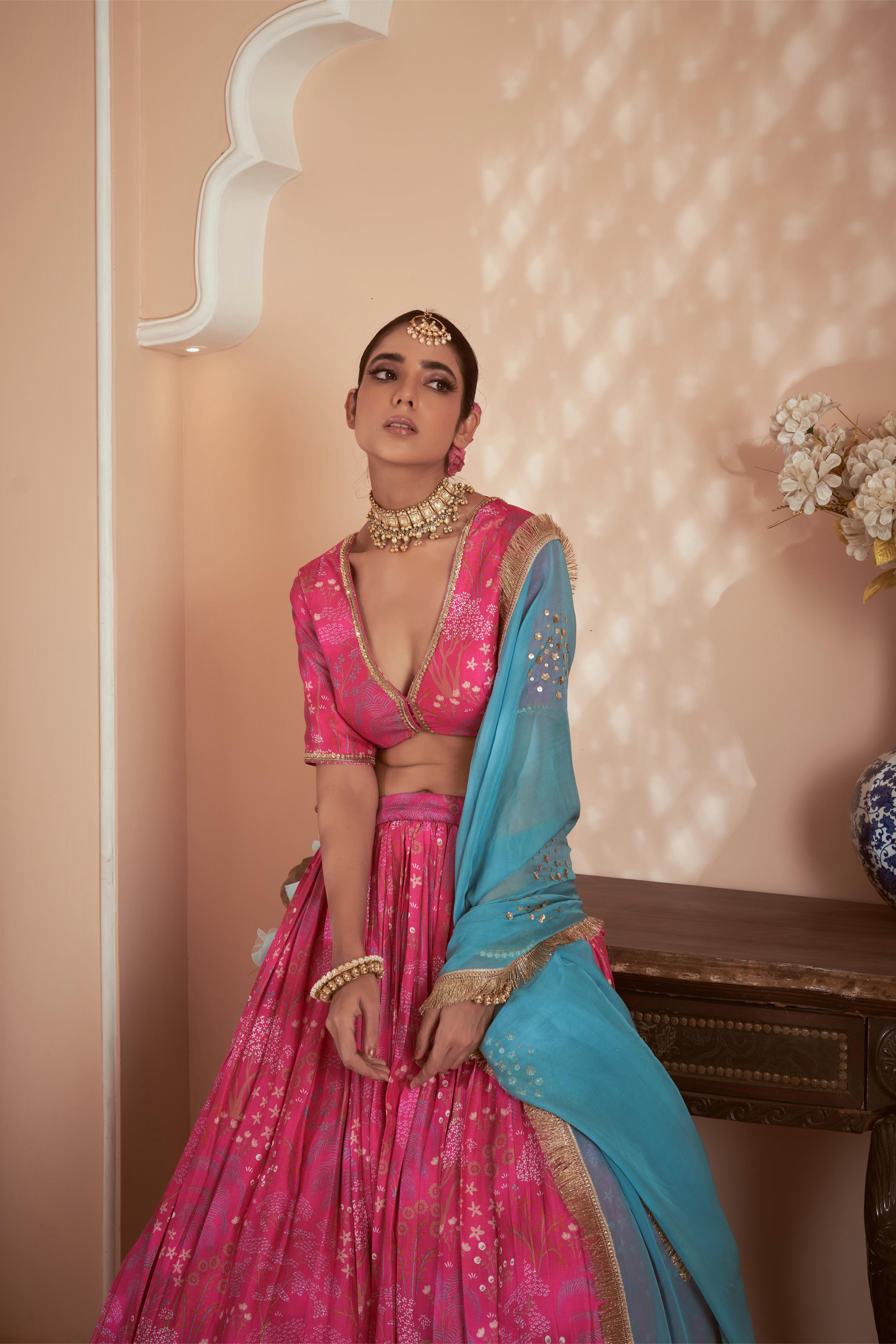 Featuring Pink signature print lehenga set paired with blue organza dupatta embellished with hand embroidery