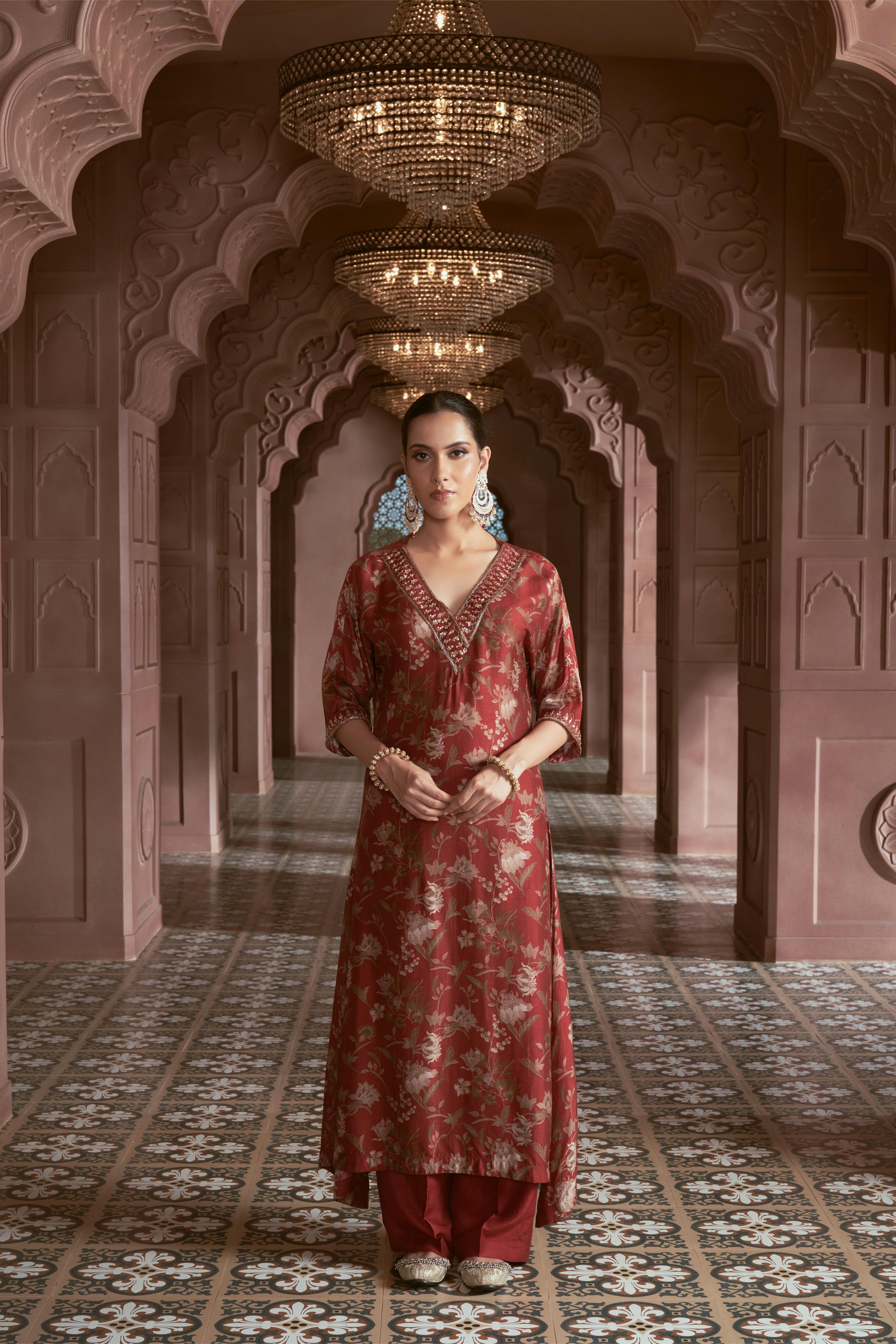 Featuring maroon floral print silk kurta with hand embroidery paired with silk pants