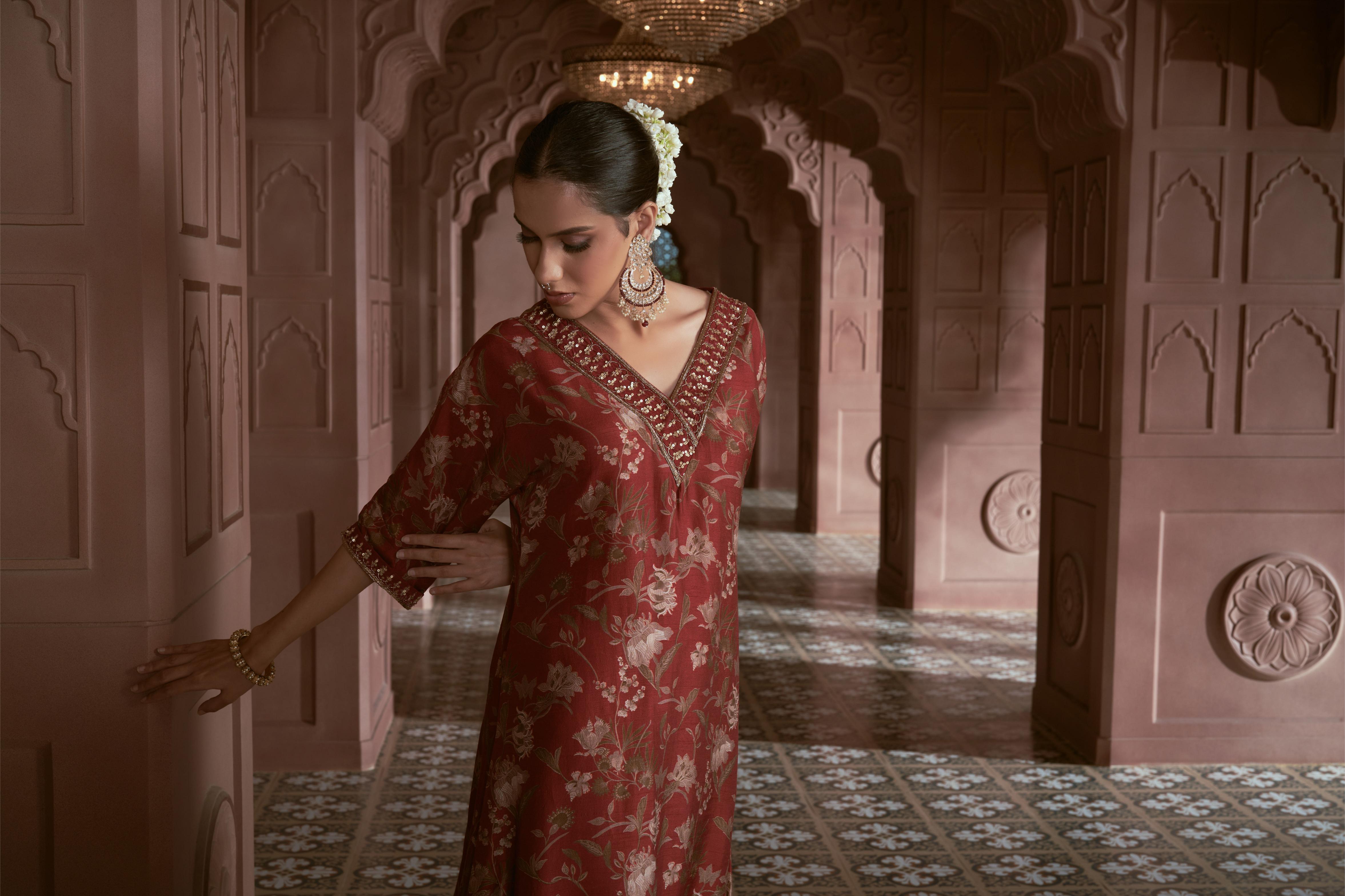 Featuring maroon floral print silk kurta with hand embroidery paired with silk pants