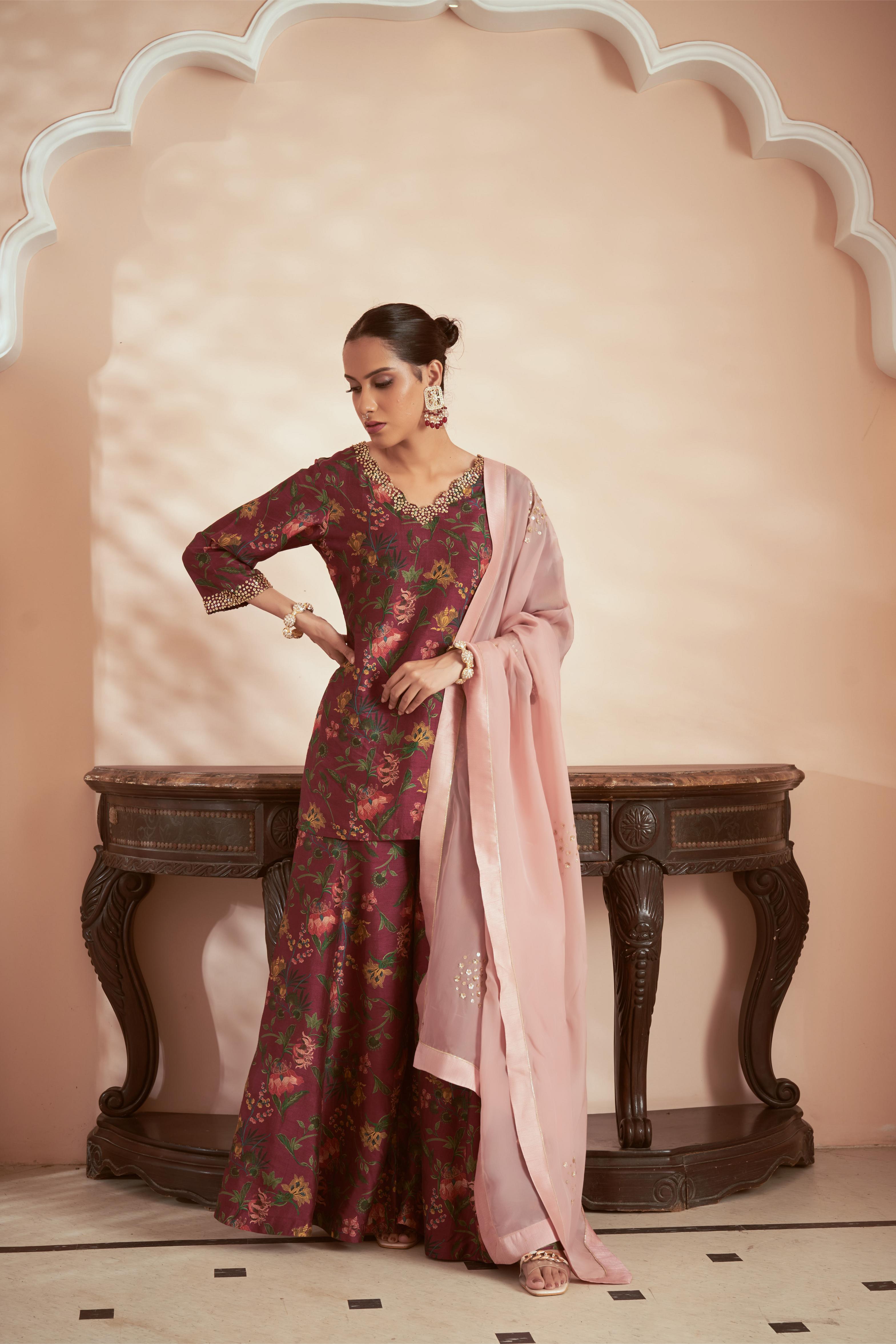 Featuring dark magenta signature print kurta sharara set paired with onion pink organza dupatta embellished with hand embroidery