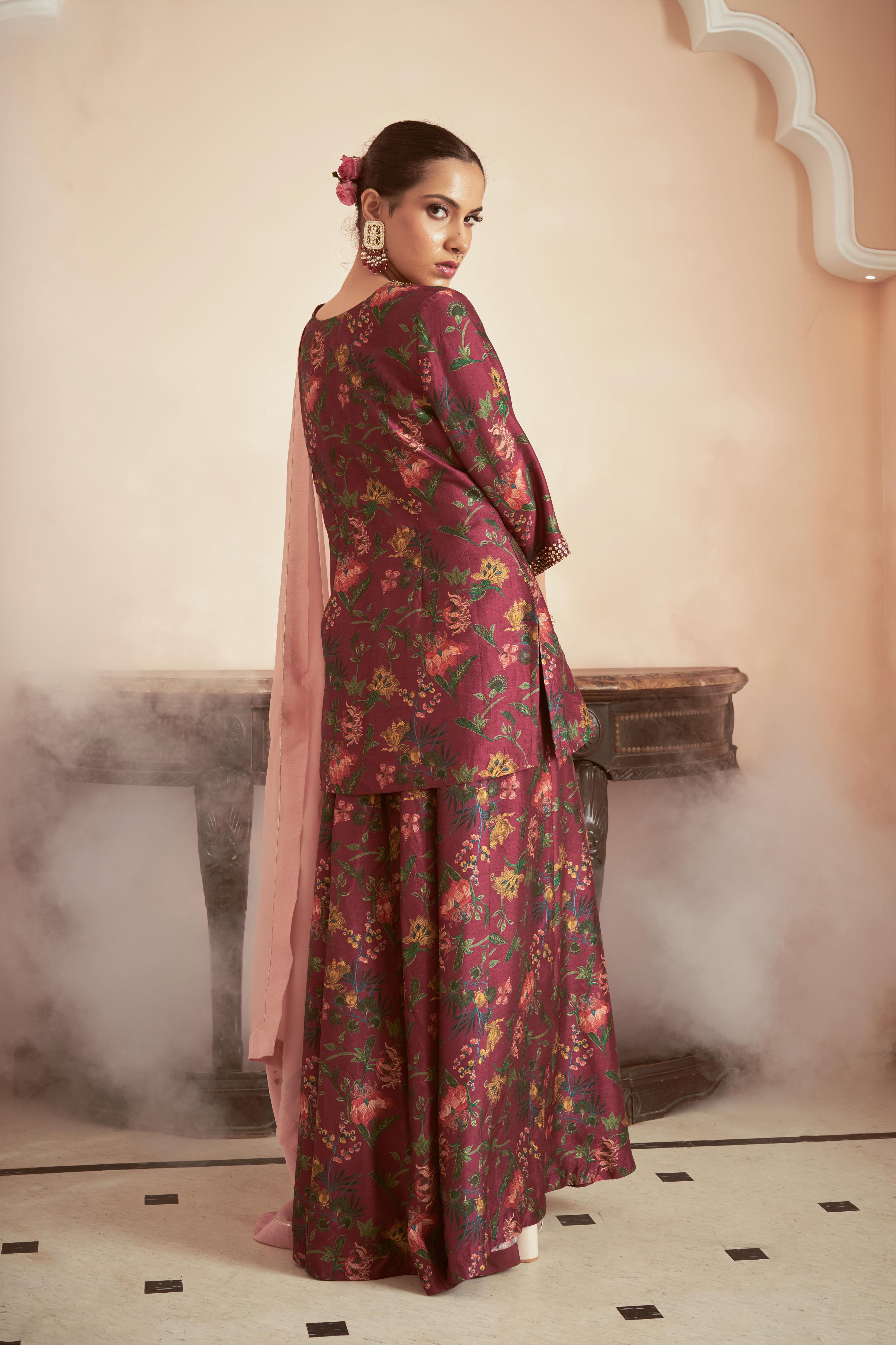 Featuring dark magenta signature print kurta sharara set paired with onion pink organza dupatta embellished with hand embroidery