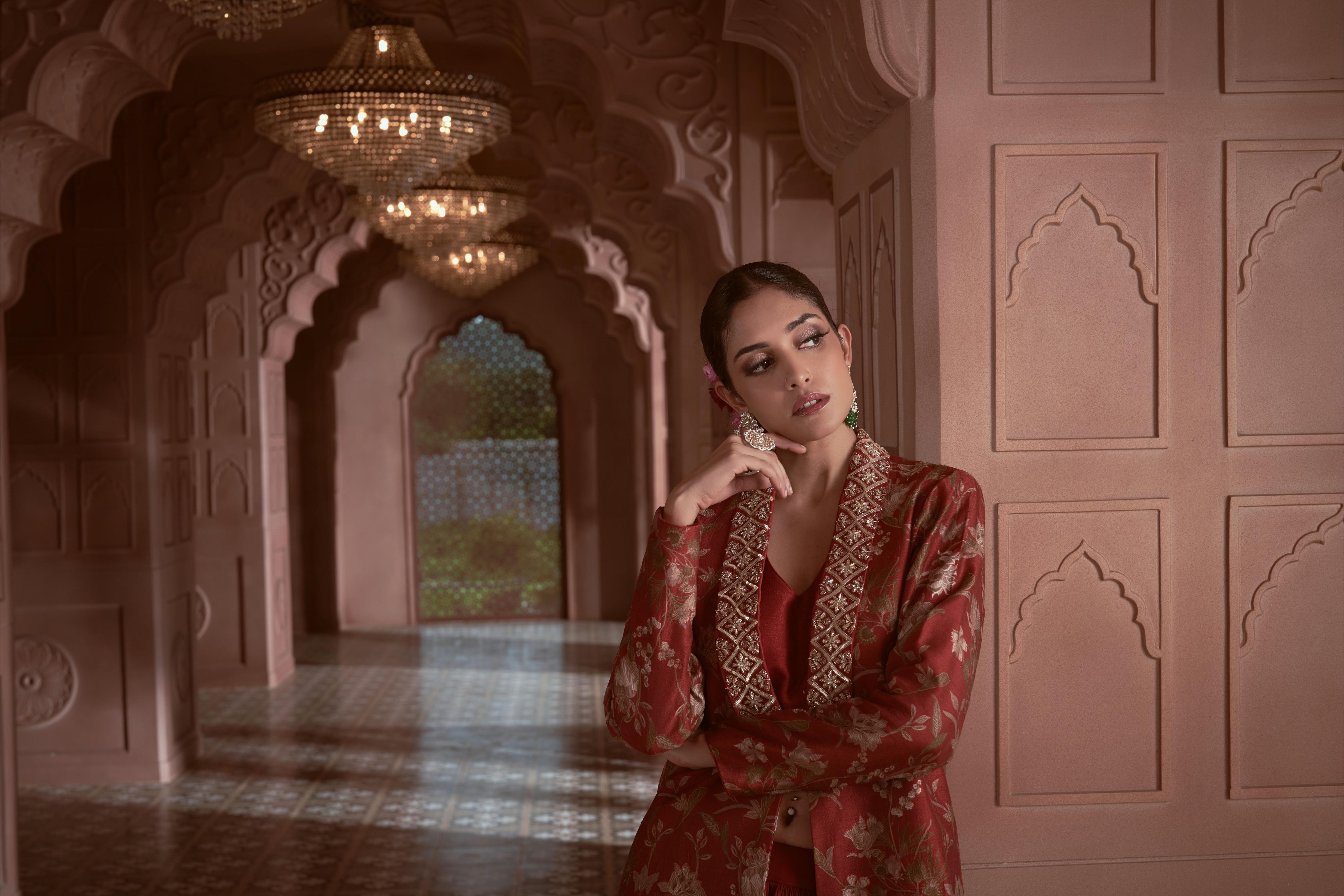 Featuring Maroon floral print silk jacket with hand embroidery on the collar paired with gathered crepe skirt and bustier