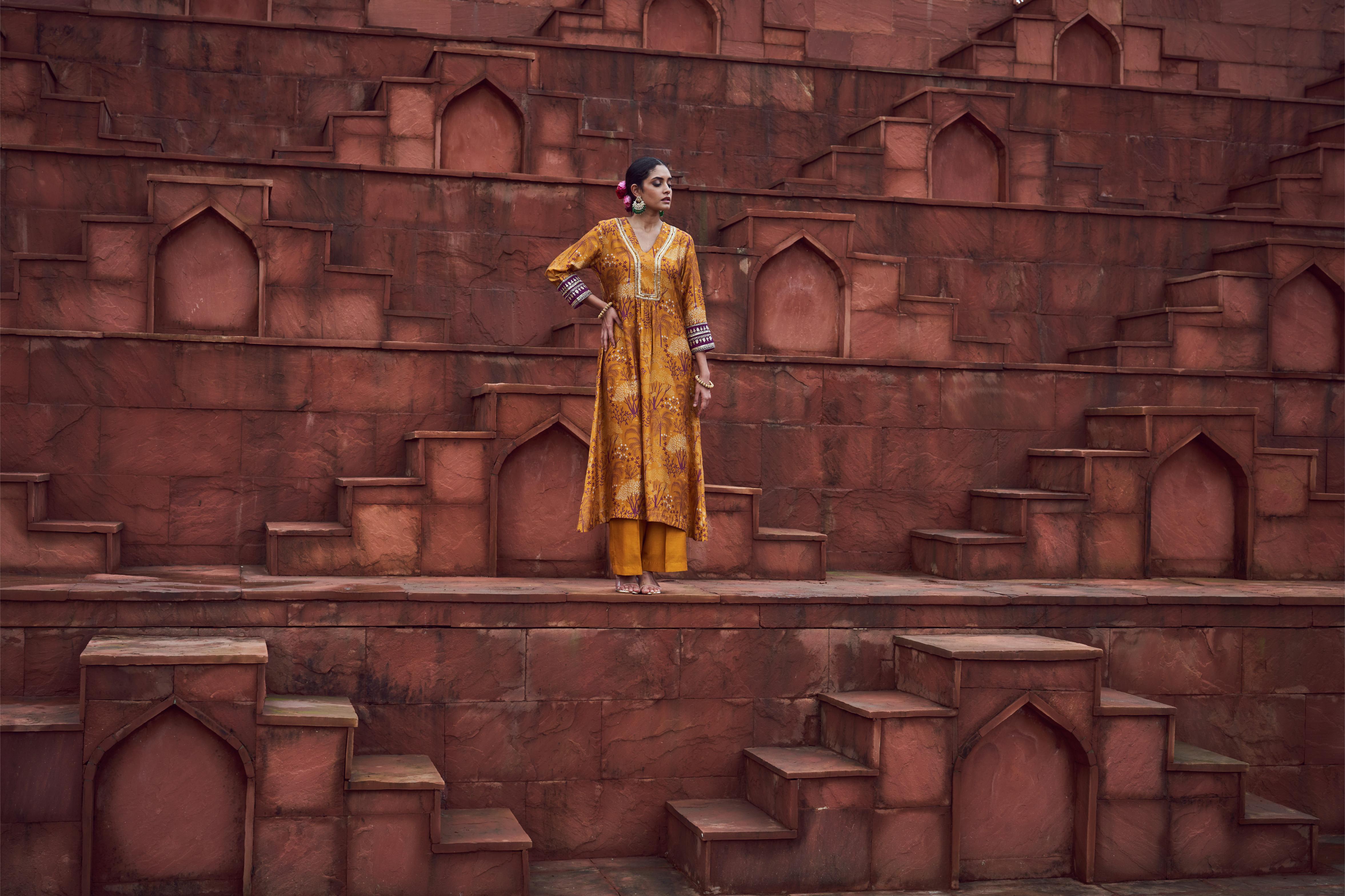 Featuring ochre yellow printed kurta with embroidery paired with silk pants