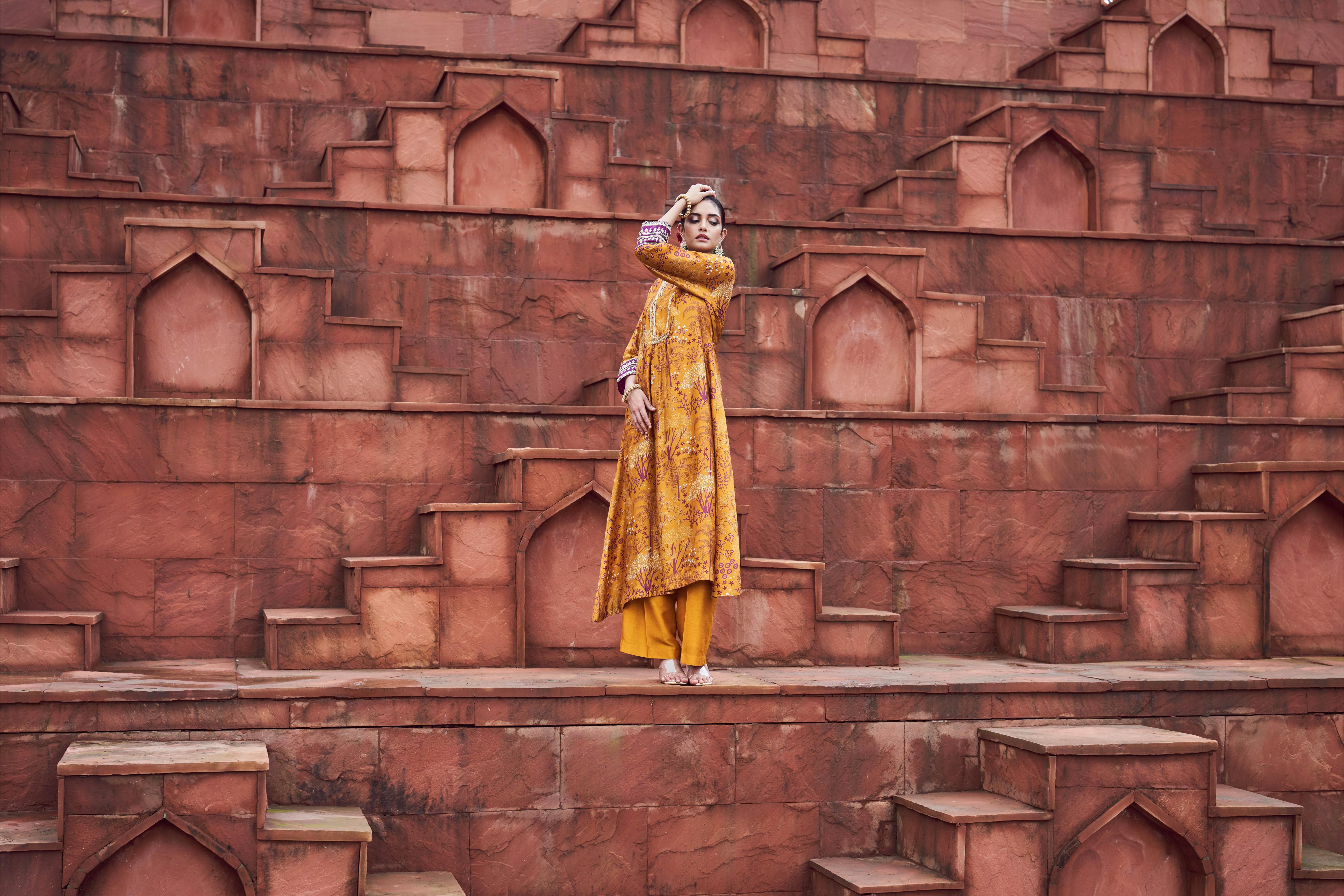 Featuring ochre yellow printed kurta with embroidery paired with silk pants