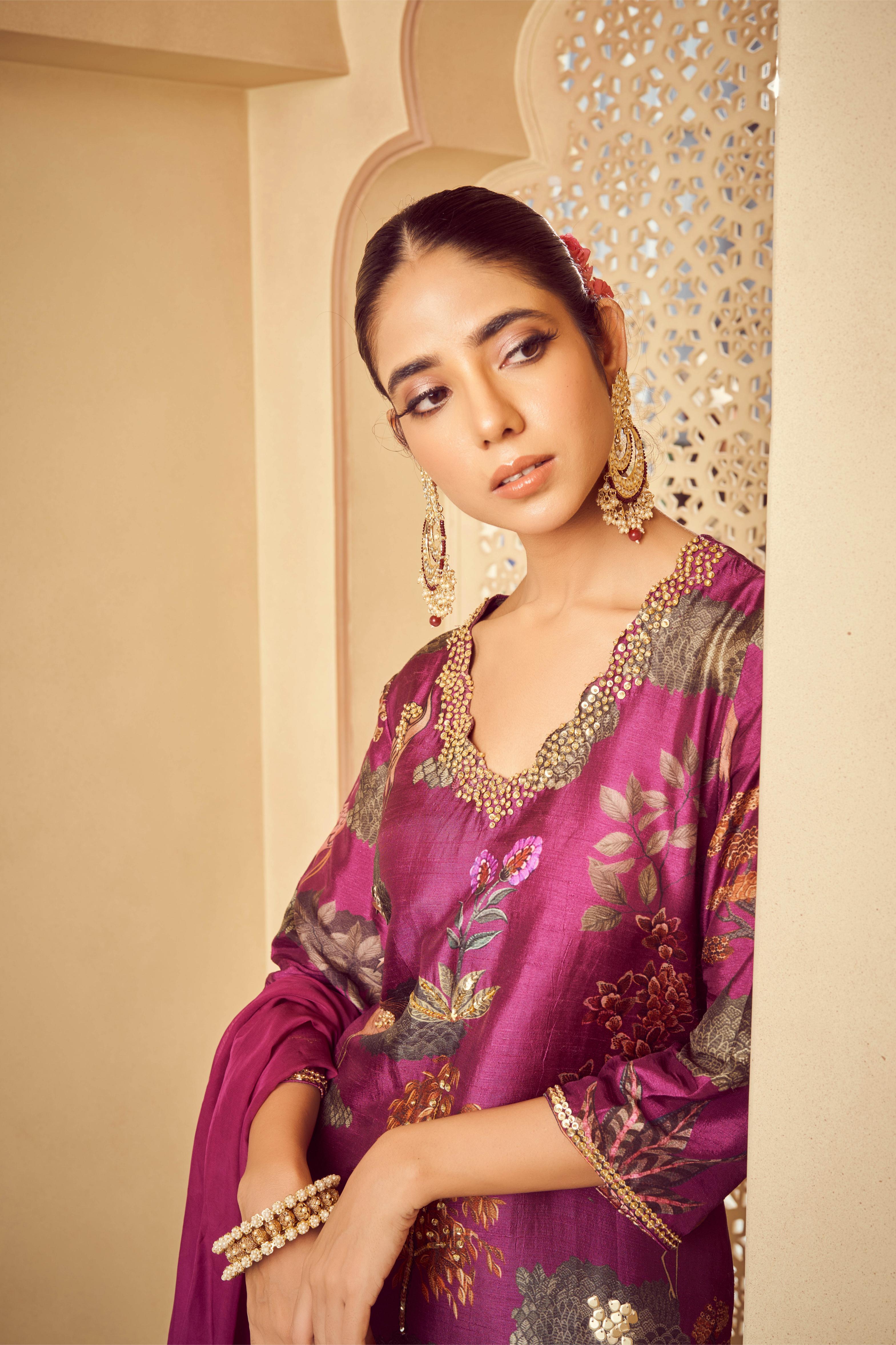 Featuring purple printed kurta with embroidery paired with silk pants and organza dupatta