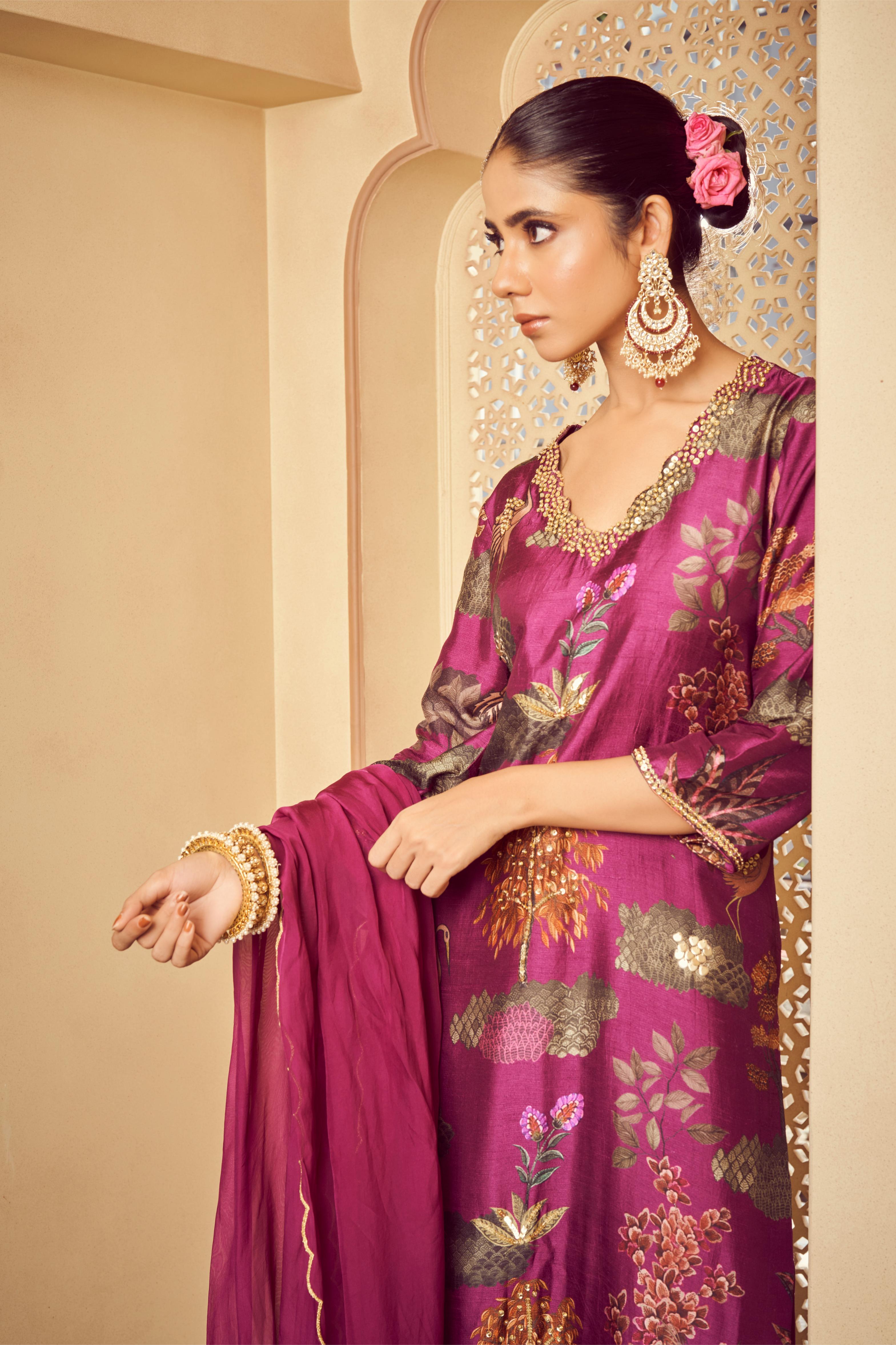 Featuring purple printed kurta with embroidery paired with silk pants and organza dupatta